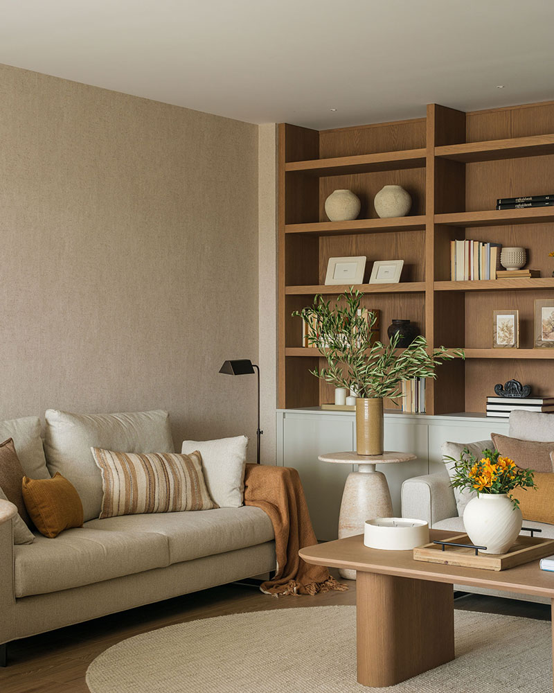 Salón de Casa Kane con mobiliario de madera y tonos naturales